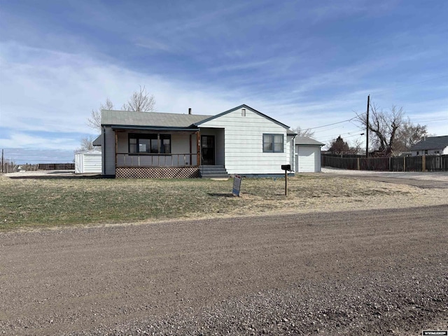 610 Charles St, Douglas, WY 82633 - ranch-style home with dirt driveway and a porch