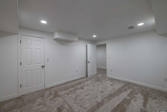 basement featuring light colored carpet