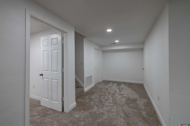 basement featuring light colored carpet