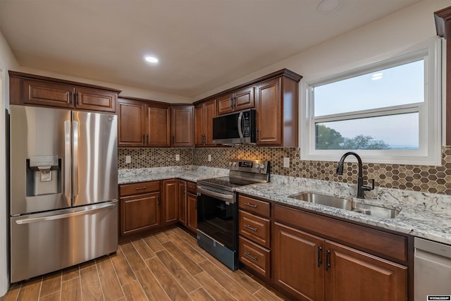 kitchen with decorative backsplash, stainless steel appliances, dark hardwood / wood-style floors, and sink