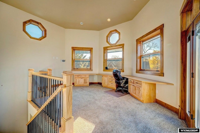 office featuring built in desk and light colored carpet