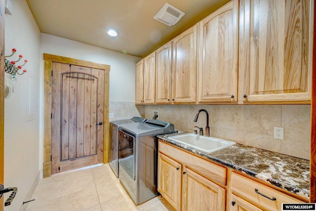 laundry area featuring cabinets, independent washer and dryer, light tile patterned flooring, and sink