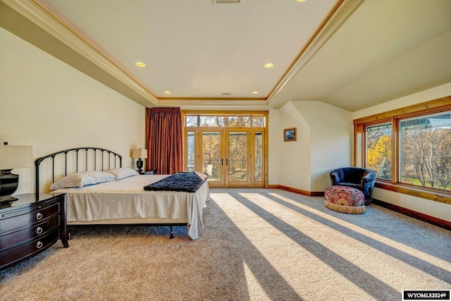 carpeted bedroom featuring crown molding, a tray ceiling, and french doors