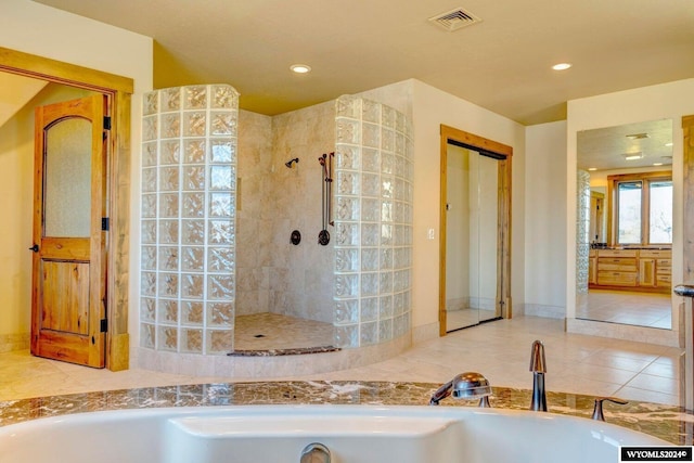 bathroom with tile patterned floors and independent shower and bath