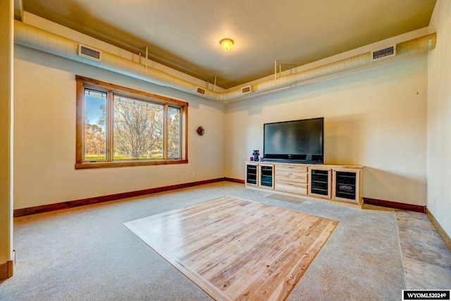 unfurnished living room featuring carpet flooring