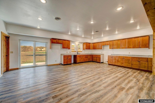 kitchen featuring a textured ceiling, light hardwood / wood-style flooring, and sink