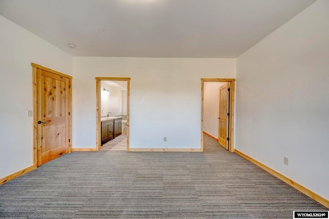 unfurnished bedroom with light carpet and ensuite bathroom