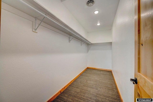 walk in closet featuring carpet