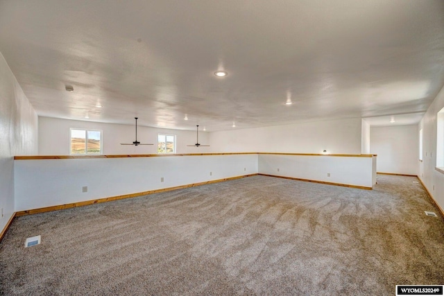 empty room with carpet and ceiling fan