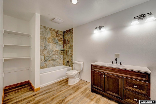 full bathroom featuring hardwood / wood-style floors, vanity, toilet, and shower / bathing tub combination