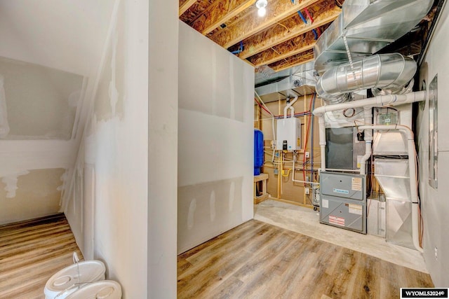 utility room featuring tankless water heater