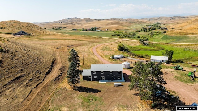 birds eye view of property with a mountain view and a rural view