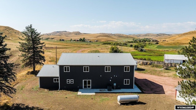 drone / aerial view featuring a mountain view and a rural view