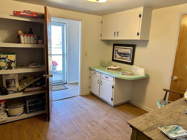 kitchen featuring white cabinets and light hardwood / wood-style flooring