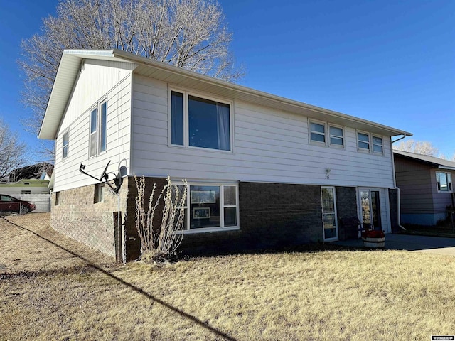 rear view of house featuring a lawn