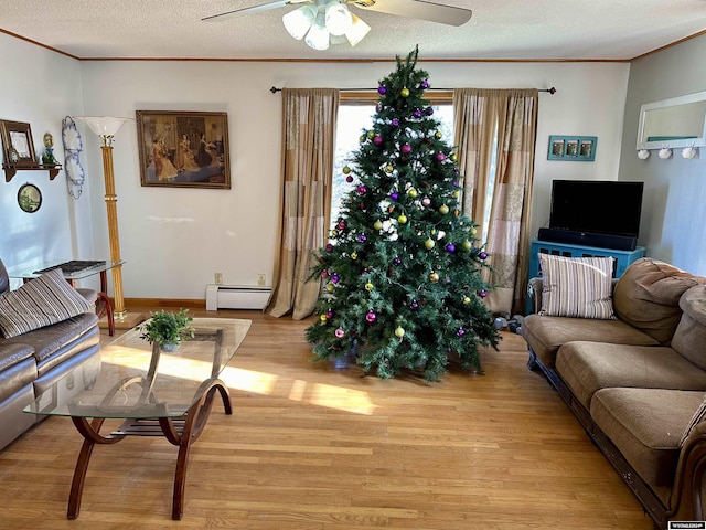 living room with a textured ceiling, crown molding, light hardwood / wood-style flooring, and a baseboard radiator