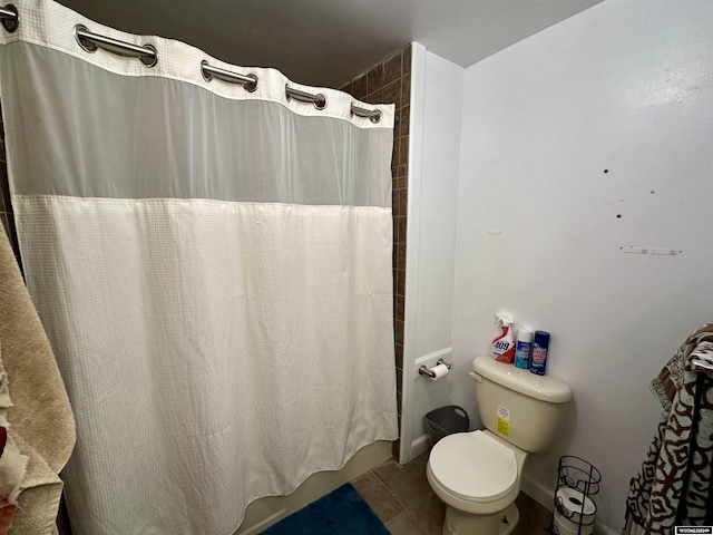 bathroom featuring tile patterned floors, shower / bath combo, and toilet