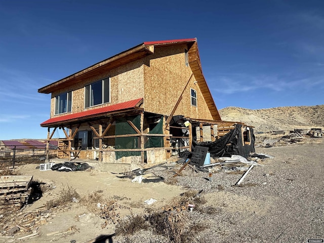 back of house featuring a mountain view