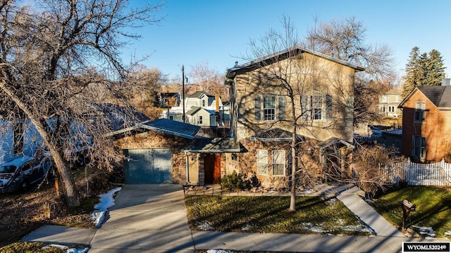 view of property with a front yard and a garage