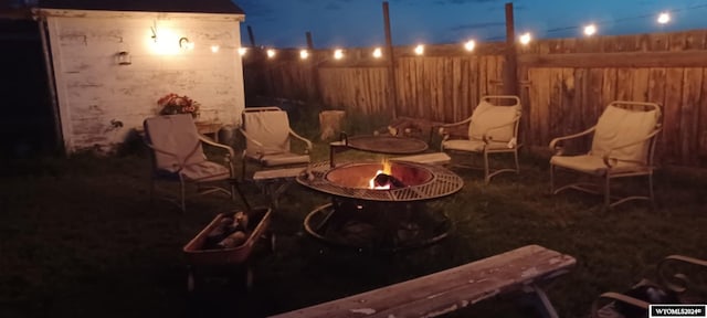 patio at twilight featuring a fire pit