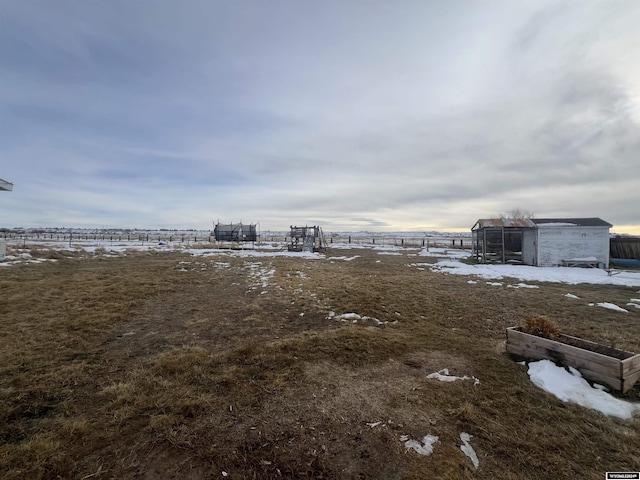 view of yard featuring an outdoor structure and a rural view