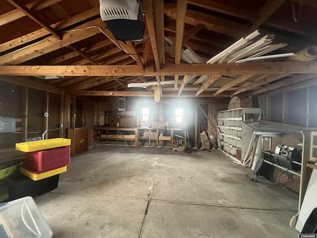 miscellaneous room featuring concrete floors and lofted ceiling