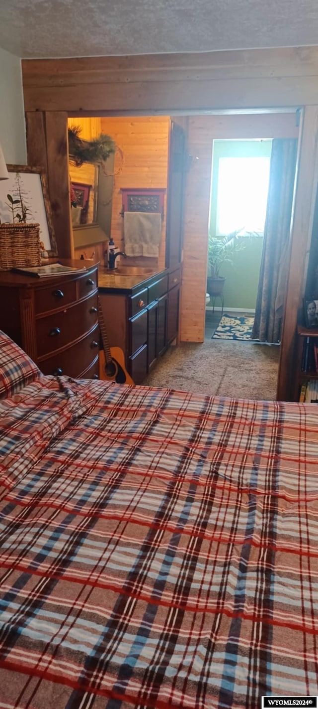 bedroom featuring carpet and a textured ceiling