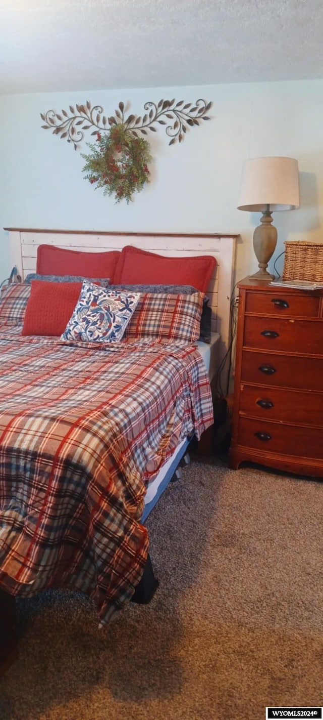 carpeted bedroom featuring a textured ceiling