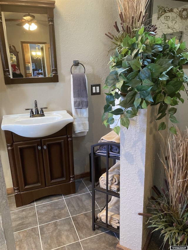 bathroom with tile patterned floors, vanity, and ceiling fan