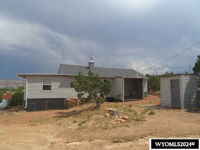 rear view of house with a shed