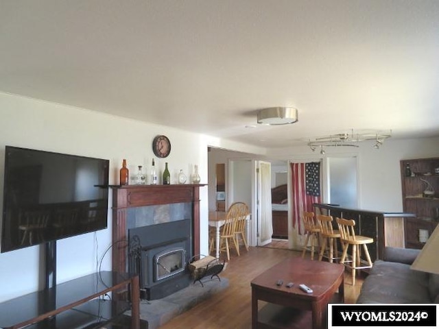 living room with hardwood / wood-style flooring and a wood stove