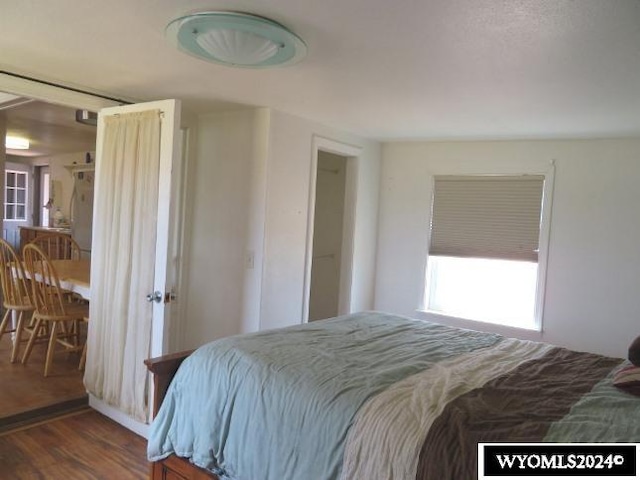 bedroom with dark wood-type flooring