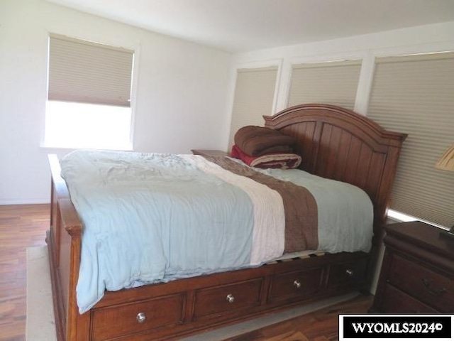 bedroom featuring dark hardwood / wood-style flooring