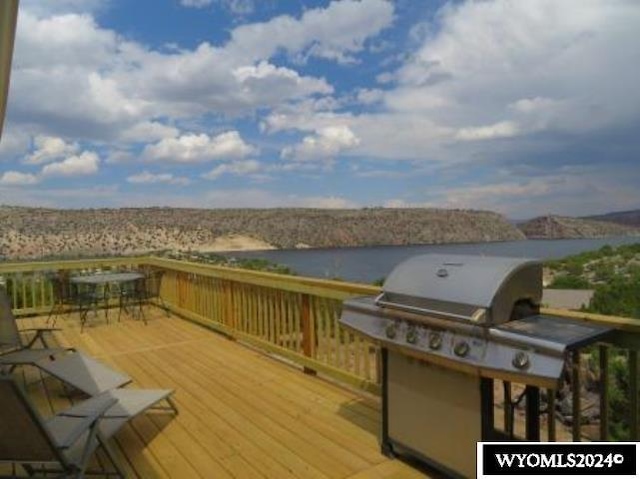 wooden deck featuring a grill and a water view