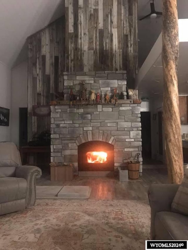 living room featuring a fireplace and lofted ceiling