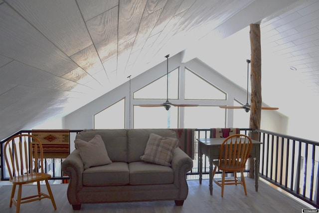 living room featuring ceiling fan, wood-type flooring, and lofted ceiling