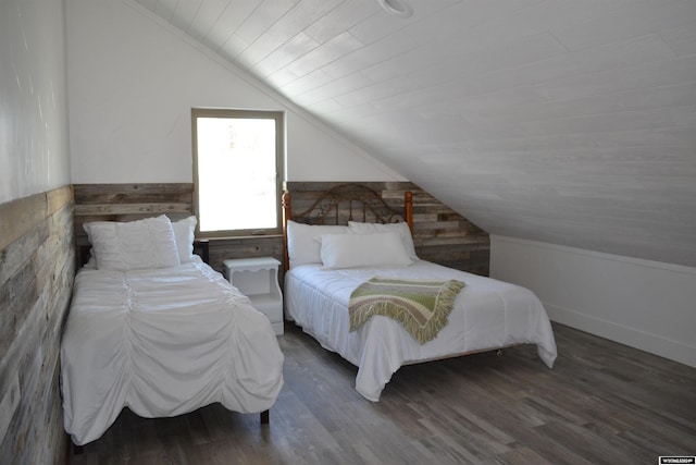 bedroom with dark hardwood / wood-style flooring and lofted ceiling