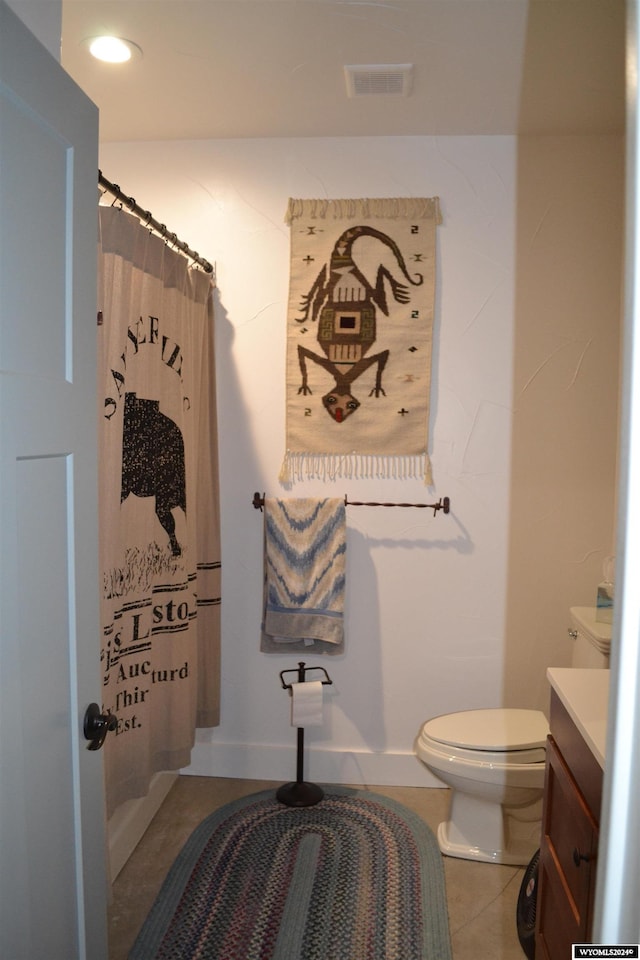 bathroom featuring tile patterned floors, walk in shower, vanity, and toilet