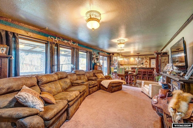 carpeted living room featuring a textured ceiling and crown molding