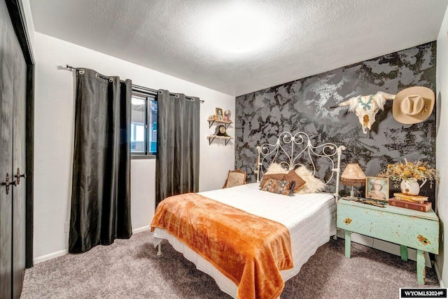 bedroom with carpet flooring, a closet, and a textured ceiling