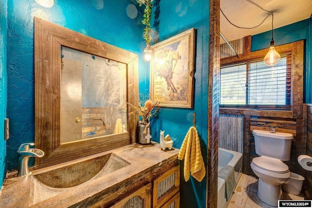 bathroom with a bath, toilet, and sink