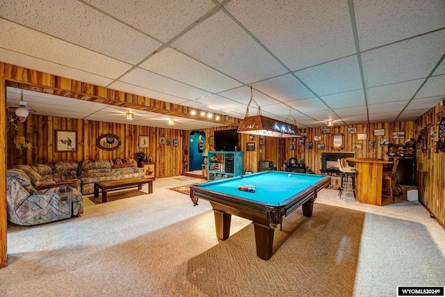 game room with carpet, a paneled ceiling, pool table, and wood walls