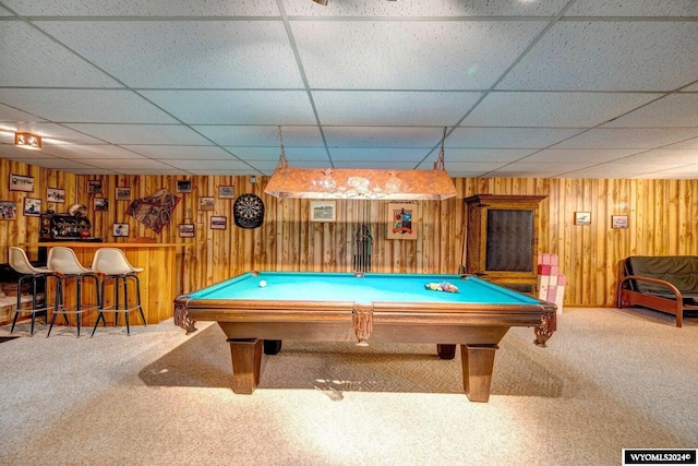 game room with a paneled ceiling, billiards, carpet floors, and wooden walls