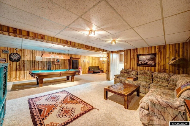 game room featuring wood walls, a drop ceiling, and carpet