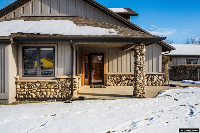 view of snow covered property entrance