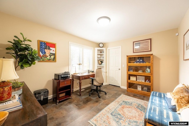 home office with dark hardwood / wood-style flooring