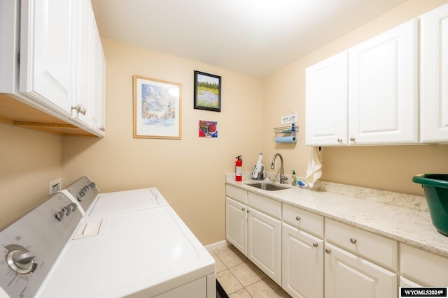 laundry area with washer and dryer, light tile patterned floors, cabinets, and sink