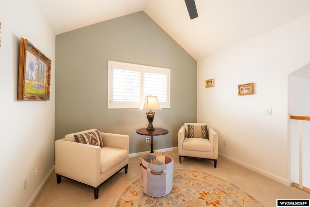 sitting room with ceiling fan, carpet floors, and lofted ceiling