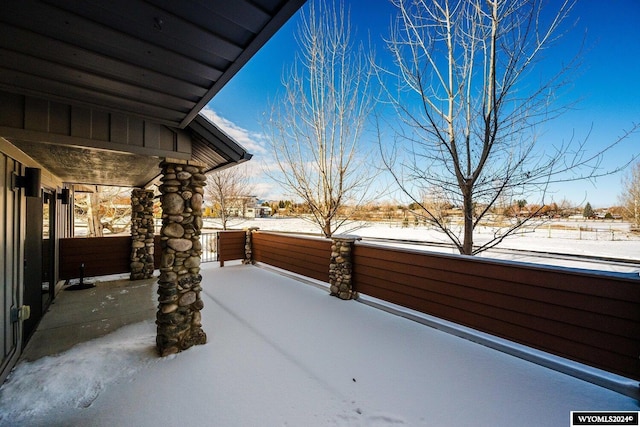 yard layered in snow with a porch