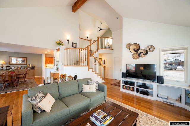 living room featuring wood-type flooring, high vaulted ceiling, and a wealth of natural light